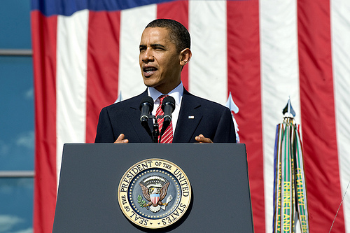 President Obama with background of broad red and white stripes of U.S. flag (credit: keyword suggest.org)